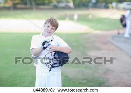 Portrait of boy wearing cricket gloves and holding helmet View Large Photo Image Stock Photo - Portrait of boy wearing cricket gloves and holding helmet. Fotosearch