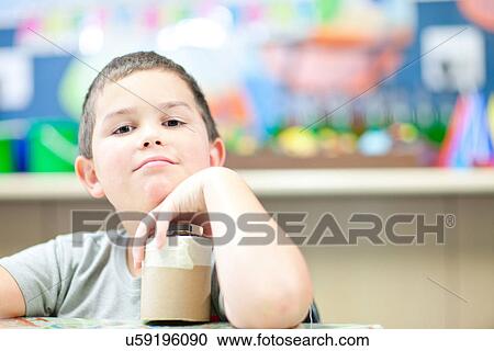 Stock Image - Portrait of boy with craft object. Fotosearch