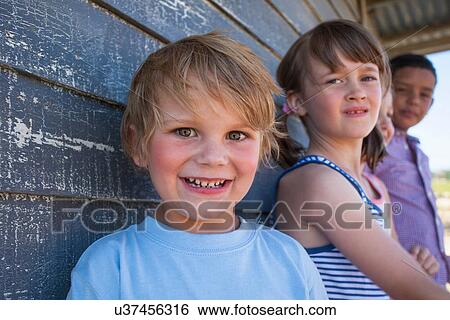 Portrait of boy with friends in background View Large Photo Image Stock Photograph - Portrait of boy with friends in background. Fotosearch