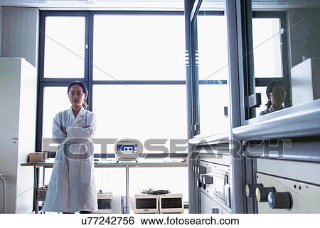 Stock Photograph - Portrait of female scientist in laboratory. Fotosearch