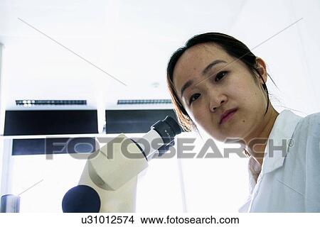 Portrait of female scientist next to microscope View Large Photo Image Picture - Portrait of female scientist next to microscope. Fotosearch