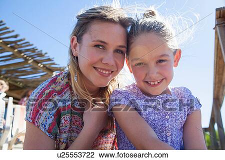 Portrait of mother and daughter in sunlight View Large Photo Image Stock Image - Portrait of mother and daughter in sunlight. Fotosearch