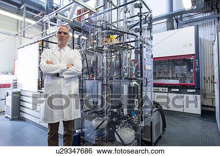 Stock Photograph - Portrait of scientist with lab equipment and machinery. Fotosearch