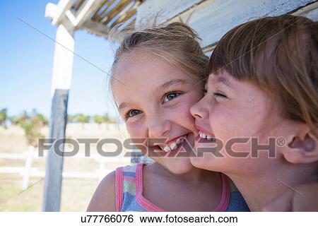 Portrait of two girls cheek to cheek smiling View Large Photo Image Stock Photograph - Portrait of two girls cheek to cheek smiling. Fotosearch