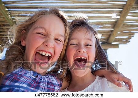 Stock Image - Portrait of two girls shouting. Fotosearch