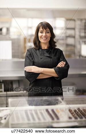 Portrait of woman in commercial kitchen with arms folded View Large Photo Image Stock Image - Portrait of woman in commercial kitchen with arms folded. Fotosearch