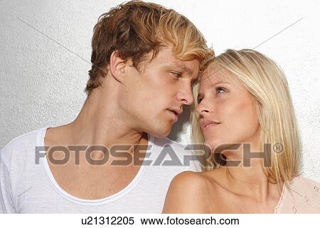 Portrait of young couple looking into each others eyes View Large Photo Image Stock Photography - Portrait of young couple looking into each others eyes. Fotosearch