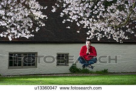 Portrait of young man on a slackline in lotus position View Large Photo Image Stock Photo - Portrait of young man on a slackline in lotus position. Fotosearch