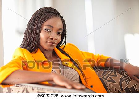 Portrait of young woman wearing orange jacket View Large Photo Image Stock Photo - Portrait of young woman wearing orange jacket. Fotosearch