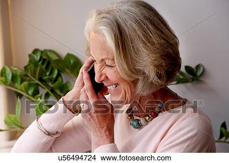Senior woman using mobile phone, smiling View Large Photo Image Picture - Senior woman using mobile phone, smiling. Fotosearch