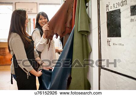 Shop assistant and customer looking at leather View Large Photo Image Stock Photograph - Shop assistant and customer looking at leather. Fotosearch