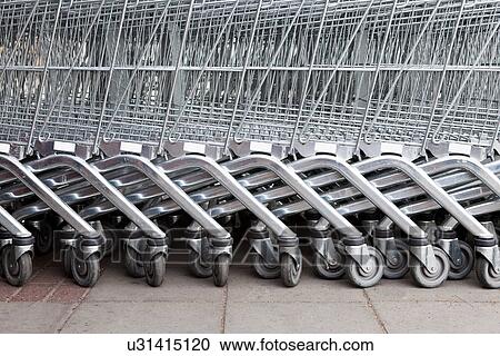 Stock Image - Shopping trolleys in a row. Fotosearch