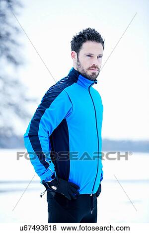 Stock Photo - Side view of man in snow field. Fotosearch