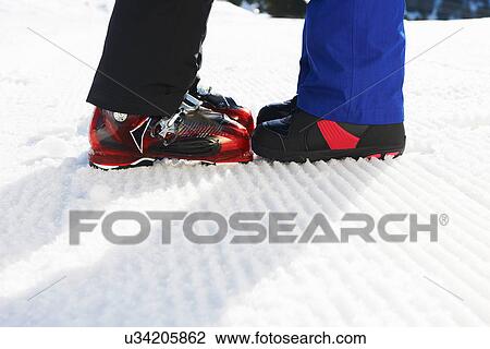 Snowboarders with boots together View Large Photo Image Stock Image - Snowboarders with boots together. Fotosearch