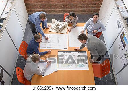 Team of architects discussing plans in meeting room View Large Photo Image Stock Photo - Team of architects discussing plans in meeting room. Fotosearch