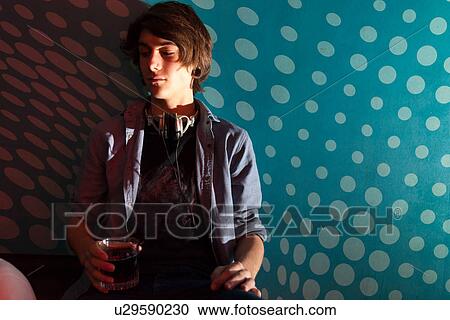 Stock Image - Teenage boy holding glass of water. Fotosearch