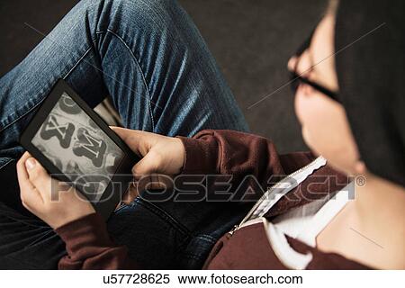 Stock Photography - Teenage boy using e-reader. Fotosearch