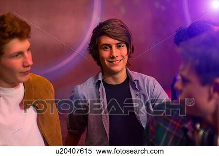 Teenage boys standing at party View Large Photo Image Stock Photography - Teenage boys standing at party. Fotosearch