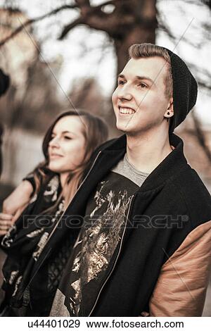 Stock Photo - Teenage couple standing in park. Fotosearch