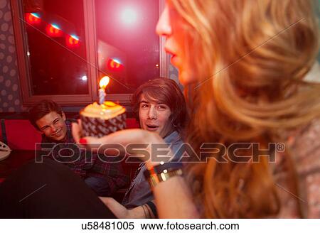 Teenage girl blowing out candle on birthday cake View Large Photo Image Stock Photography - Teenage girl blowing out candle on birthday cake. Fotosearch