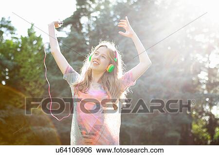 Teenage girl listening to mp3 player and dancing View Large Photo Image Stock Photograph - Teenage girl listening to mp3 player and dancing. Fotosearch