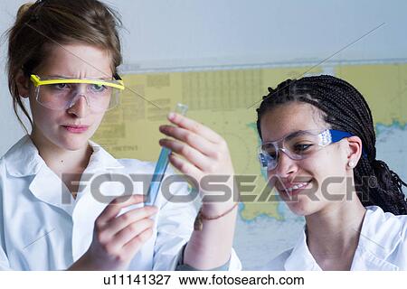 Teenage girls looking at test tube View Large Photo Image Stock Photo - Teenage girls looking at test tube. Fotosearch