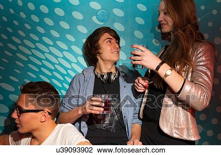 Teenagers holding drinking glasses View Large Photo Image Stock Image - Teenagers holding drinking glasses. Fotosearch