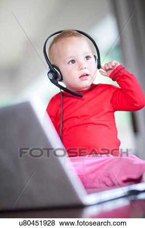 Toddler girl wearing telephone headset View Large Photo Image Stock Photo - Toddler girl wearing telephone headset. Fotosearch