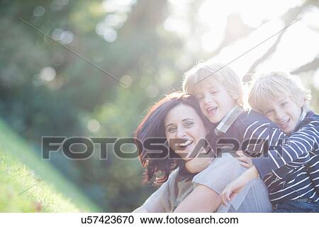 Twin boys on top of mother View Large Photo Image Stock Image - Twin boys on top of mother. Fotosearch