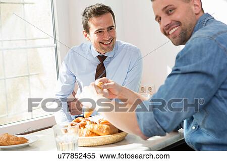 Two men having breakfast together View Large Photo Image Stock Photography - Two men having breakfast together. Fotosearch