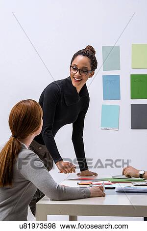 Two women discussing ideas in design studio View Large Photo Image Stock Photo - Two women discussing ideas in design studio. Fotosearch