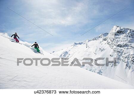 Two women skiing View Large Photo Image Stock Image - Two women skiing. Fotosearch