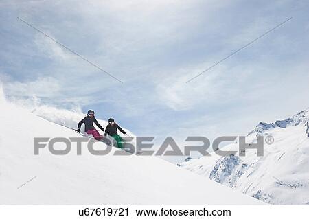 Two women skiing View Large Photo Image Stock Image - Two women skiing. Fotosearch