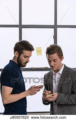 Two young male designers sharing ideas View Large Photo Image Stock Photography - Two young male designers sharing ideas. Fotosearch