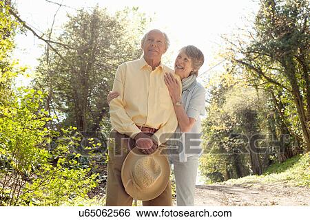 Wife posing with husband holding her straw hat View Large Photo Image Stock Photograph - Wife posing with husband holding her straw hat. Fotosearch