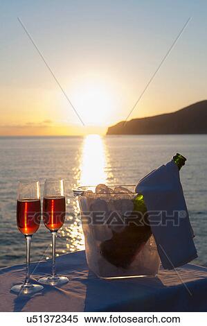 Wine glasses and bottle in ice bucket with sea in background View Large Photo Image Stock Photography - Wine glasses and bottle in ice bucket with sea in background. Fotosearch