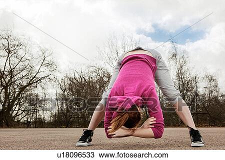 Woman doing bending forward exercise View Large Photo Image Stock Image - Woman doing bending forward exercise. Fotosearch