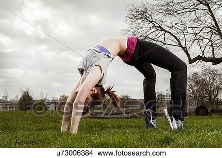 Picture - Woman in backbend yoga pose. Fotosearch
