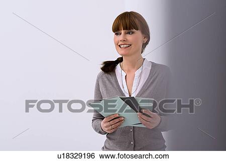 Woman in design studio holding swatch samples View Large Photo Image Stock Photograph - Woman in design studio holding swatch samples. Fotosearch