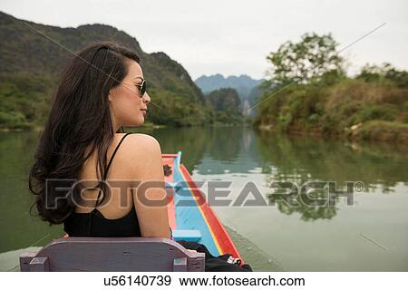 Woman on boat on Nam Song River, Vang Vieng, Laos View Large Photo Image Stock Photo - Woman on boat on Nam Song River, Vang Vieng, Laos. Fotosearch