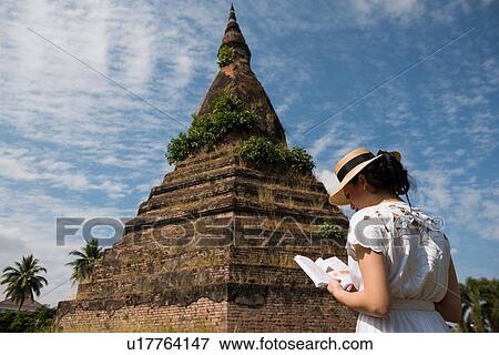 Woman reading guidebook at That Dam, Vientiane, Laos View Large Photo Image Stock Photo - Woman reading guidebook at That Dam, Vientiane, Laos. Fotosearch
