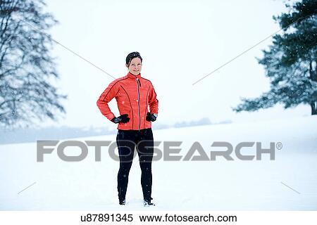 Woman standing in snow field View Large Photo Image Stock Photography - Woman standing in snow field. Fotosearch
