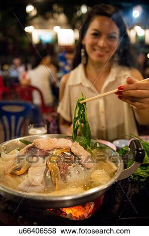 Woman using chopsticks in Korean restaurant, Luang Prabang, Laos View Large Photo Image Stock Photo - Woman using chopsticks in Korean restaurant, Luang Prabang, Laos. Fotosearch