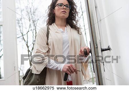 Woman using key to open door View Large Photo Image Stock Photography - Woman using key to open door. Fotosearch