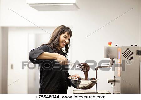 Woman with mixing bowl and melted chocolate View Large Photo Image Picture - Woman with mixing bowl and melted chocolate. Fotosearch