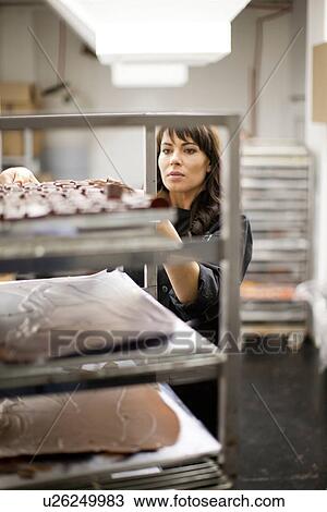 Stock Image - Woman working in commercial kitchen. Fotosearch