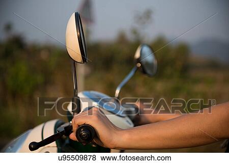 Woman's hands on moped handlebars View Large Photo Image Stock Photo - Woman's hands on moped handlebars. Fotosearch