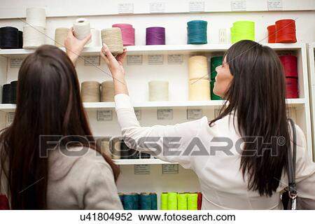 Women choosing spool of thread in store View Large Photo Image Stock Image - Women choosing spool of thread in store. Fotosearch