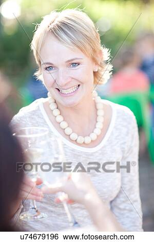Stock Photograph - Women toasting with wine. Fotosearch