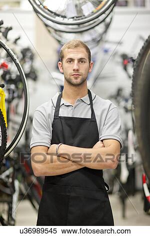 Stock Photography - Worker in bicycle shop. Fotosearch